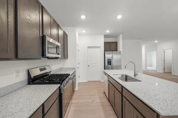 an empty room with wooden floor fireplace and windows
