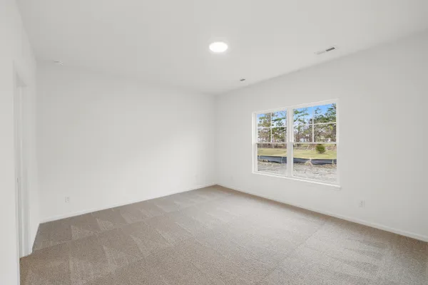 an empty room with windows and entrance