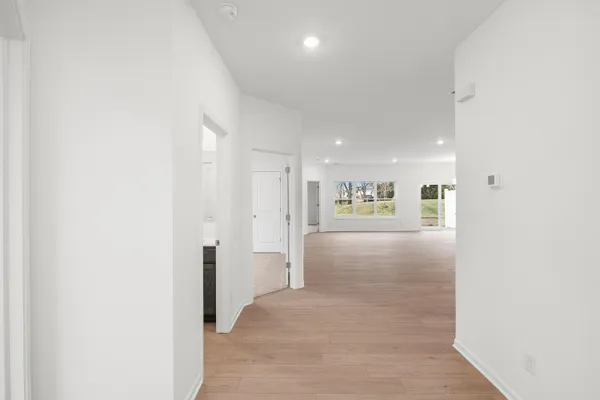 a view of a hallway with wooden shelves