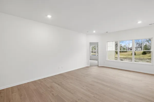 a view of kitchen with kitchen island stainless steel appliances refrigerator stove microwave and cabinets