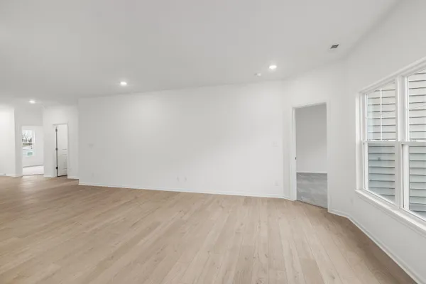 a kitchen with stainless steel appliances granite countertop a stove a sink and a refrigerator with wooden floor