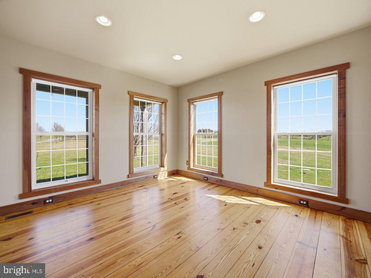 9763 Blue Spring Road Mercersburg, PA 17236 - Photo 12 of 85 an empty room with wooden floor and windows