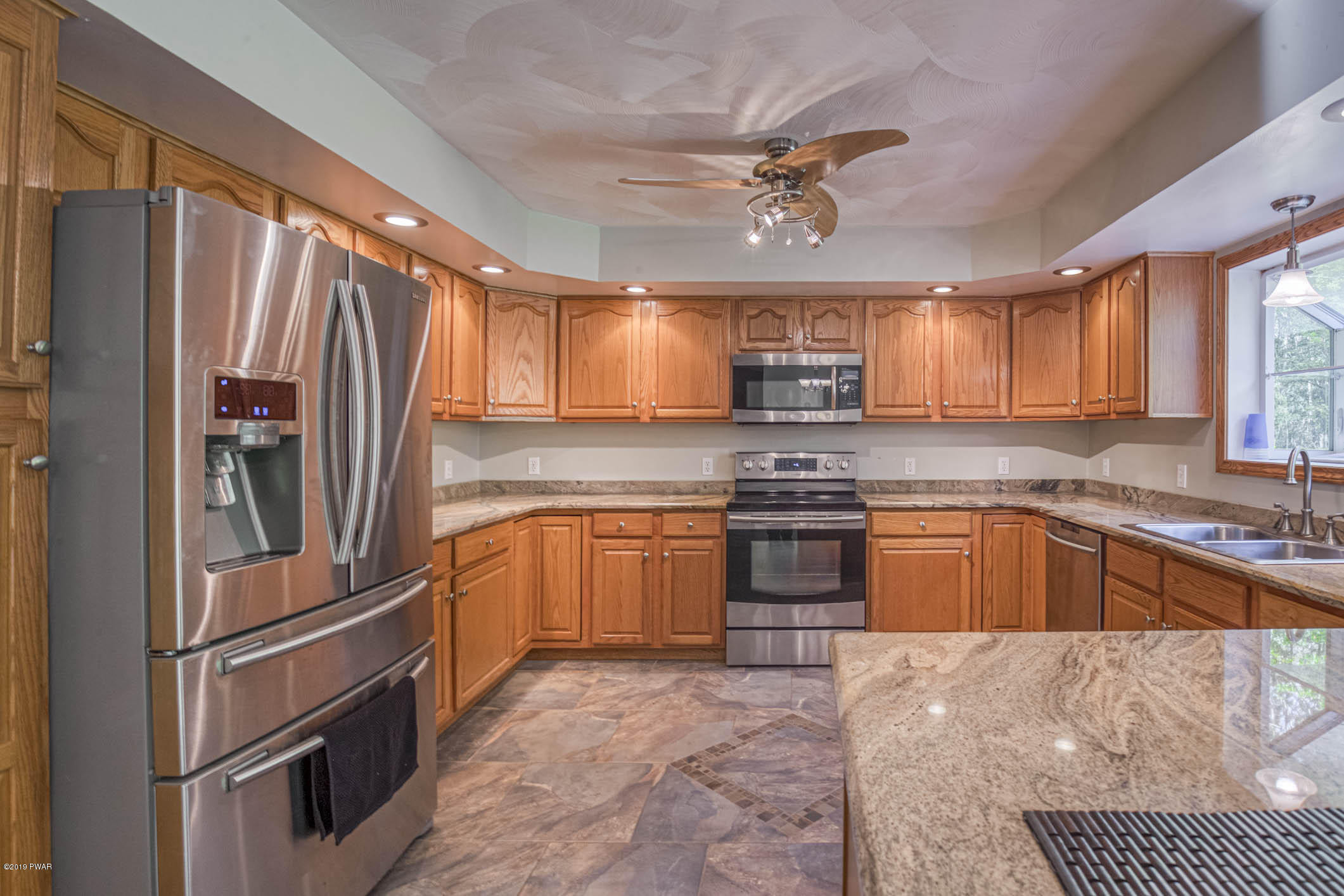 424 Old Gravity Road Lake Ariel, PA 18436 - Photo 3 of 46 a kitchen with stainless steel appliances granite countertop a refrigerator stove top oven and sink