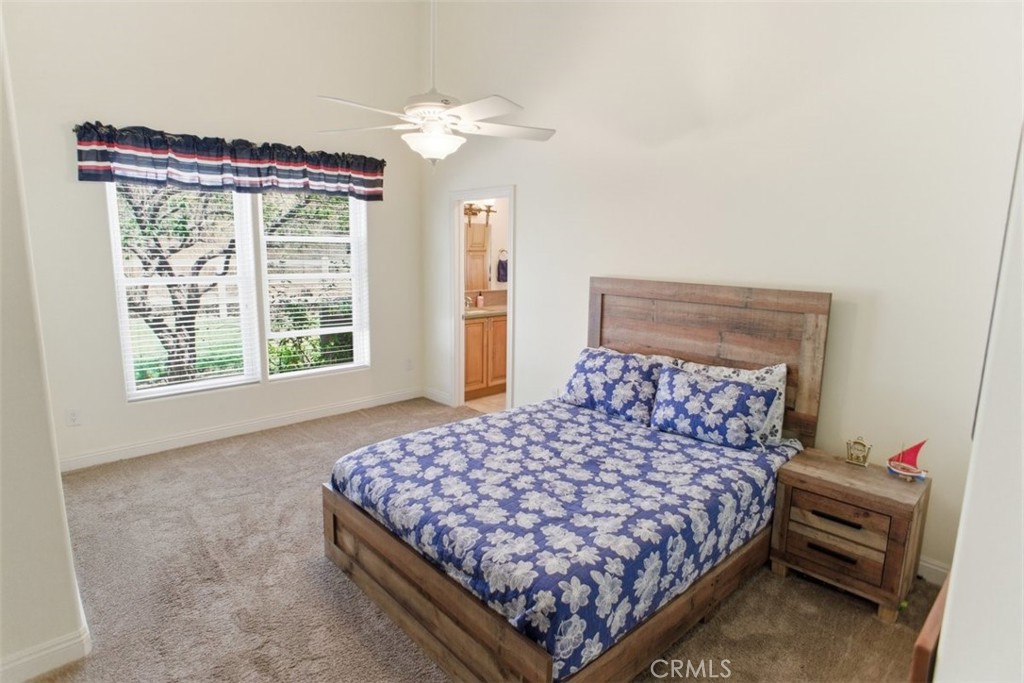 31233 Romero Canyon Road Castaic, CA 91384 - Photo 28 of 38 a bedroom with a bed chandelier and a window