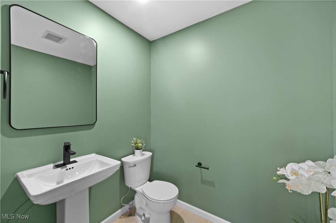 1527 Crest Road Cleveland Heights, OH 44121 - Photo 12 of 28 half Bathroom on main floor featuring baseboards, visible vents, toilet, and a sink