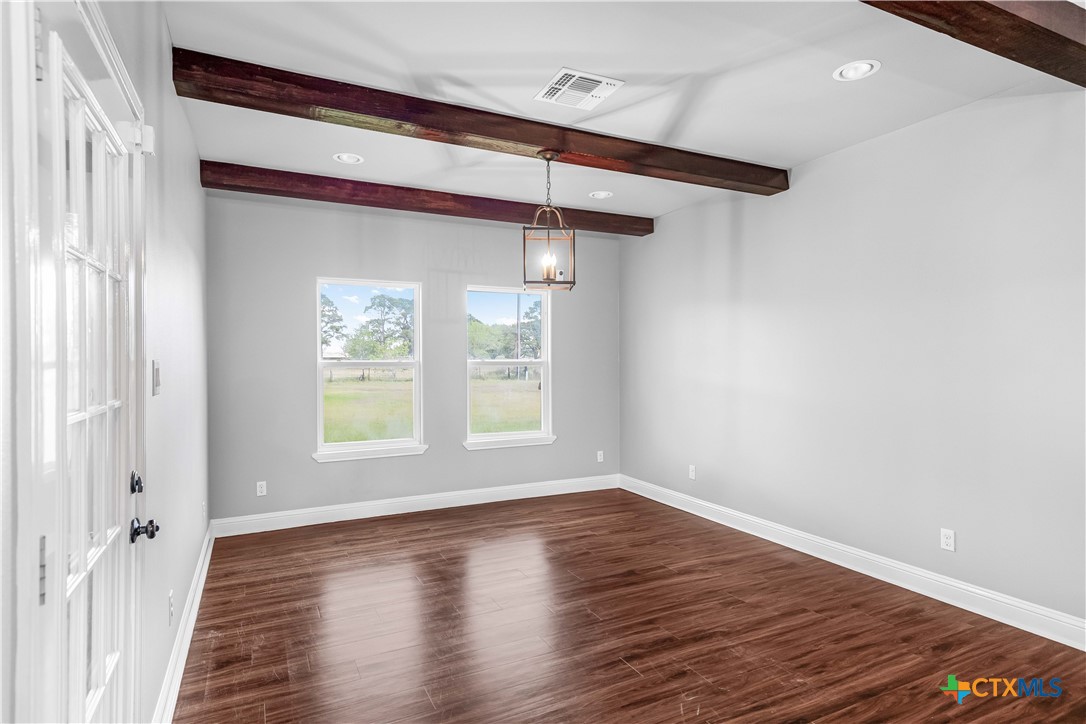 204 James Street Inez, TX 77968 - Photo 13 of 35 a view of an empty room with wooden floor and a window