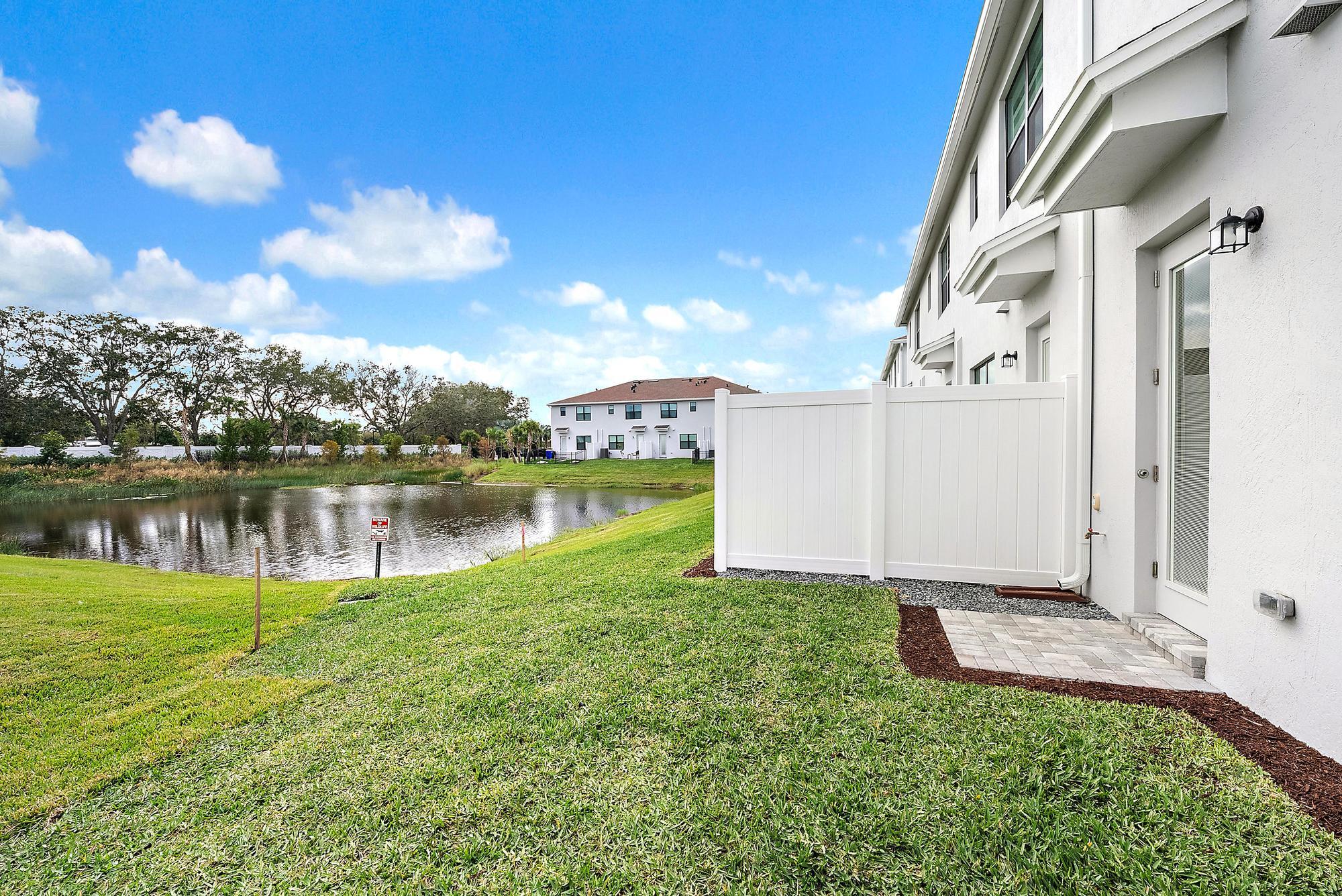 272 Southwest Sally Way Stuart, FL 34997 - Photo 2 of 25 Back Exterior & Lake View