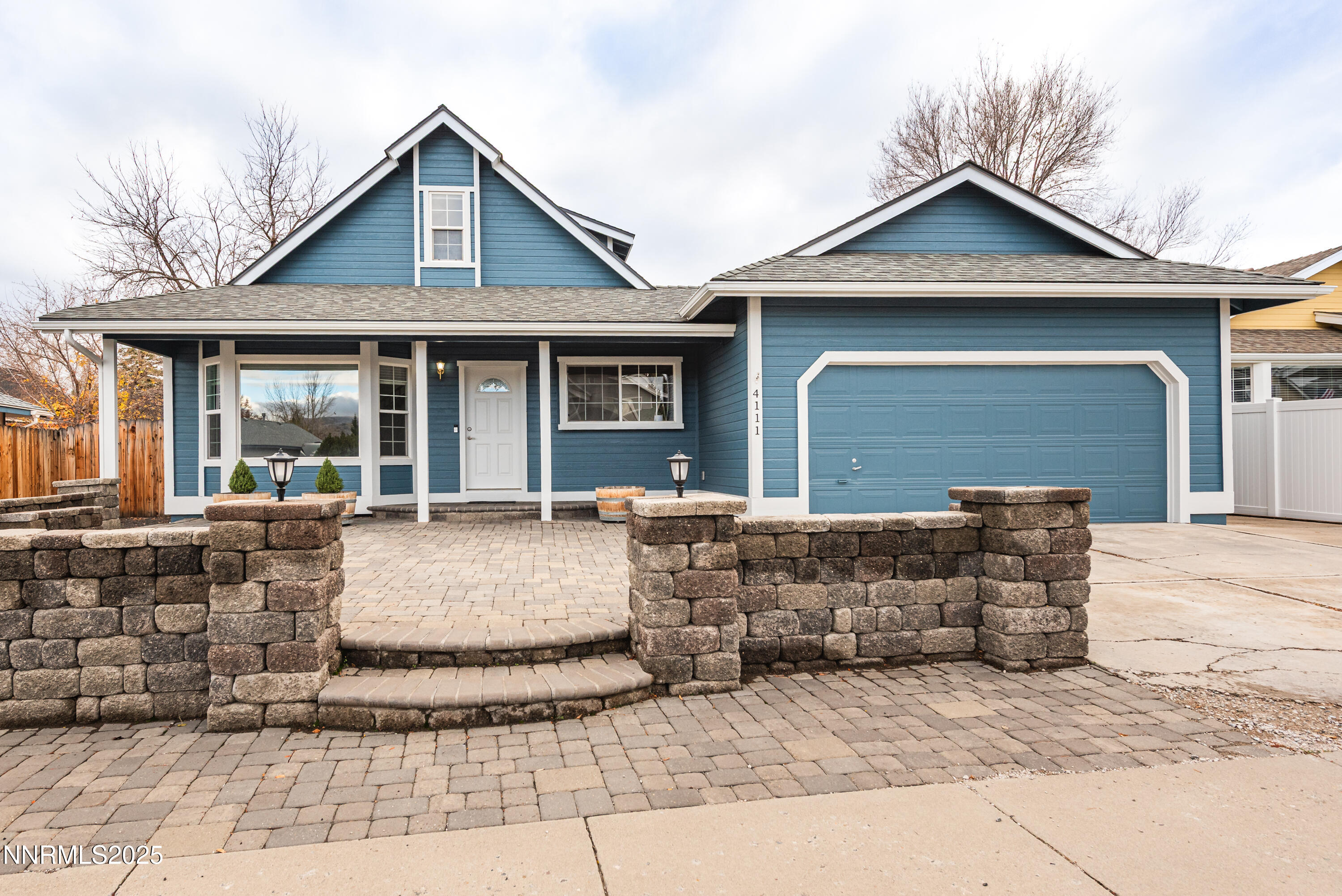 a view of a white house with large windows