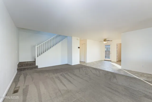 a view of an empty room with stairs