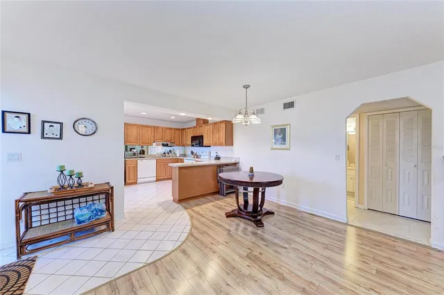 a kitchen with a sink a stove a refrigerator cabinets and a counter top space