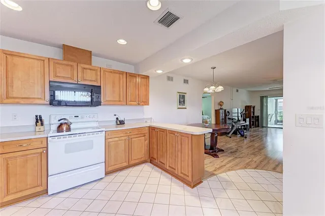 a view of a kitchen with kitchen island granite countertop lots of counter top space