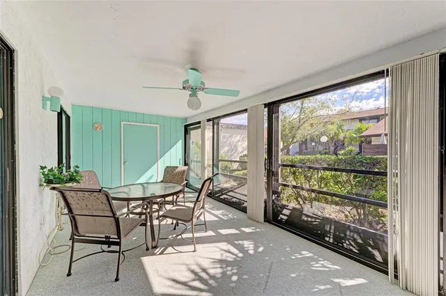 a view of a porch with furniture and a yard
