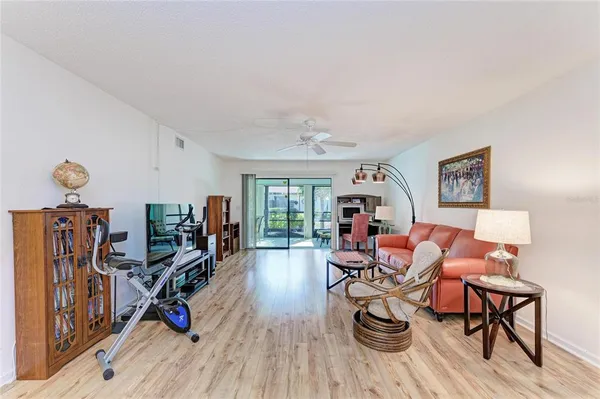 a living room with furniture a window and gym equipment