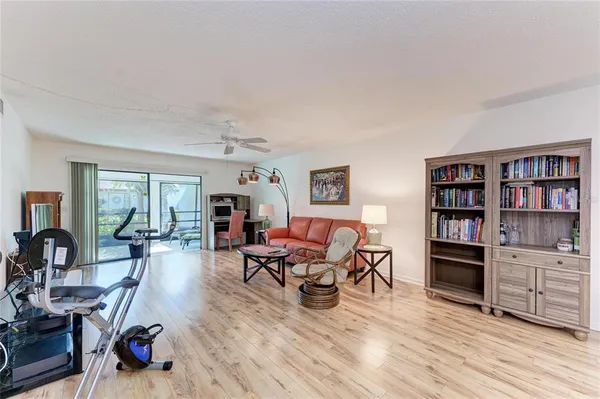 a living room with furniture and a wooden floor