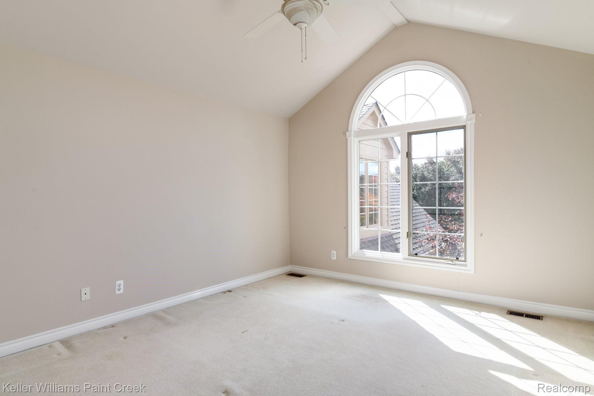 1163 Autumnview Drive Rochester, MI 48307 - Photo 20 of 34 Additional bedroom with a large arched window, cathedral ceilings, and direct bath access.