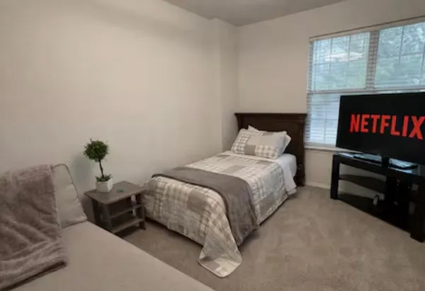 a bed room with a bed and a potted plant