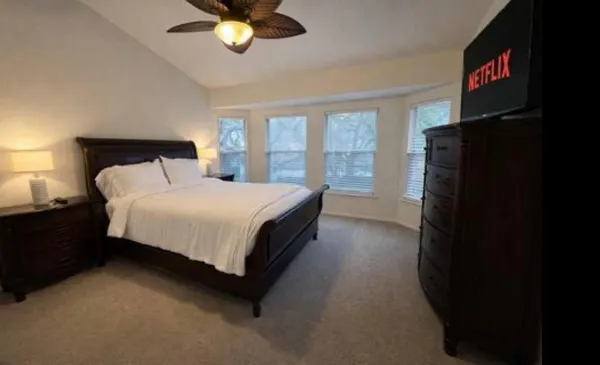 a bed sitting in a bedroom next to a window