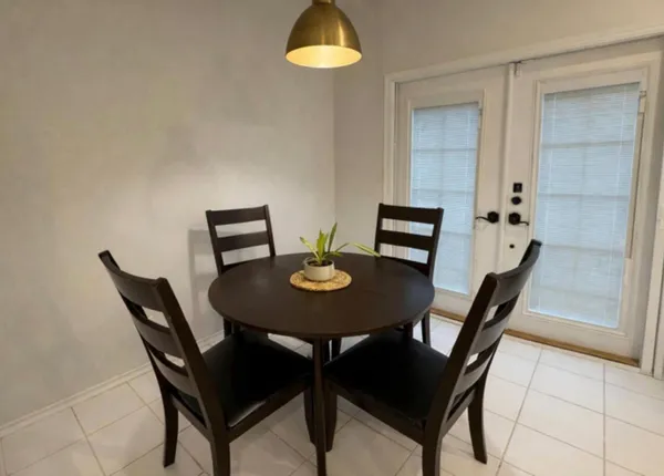 a balcony with table and chairs