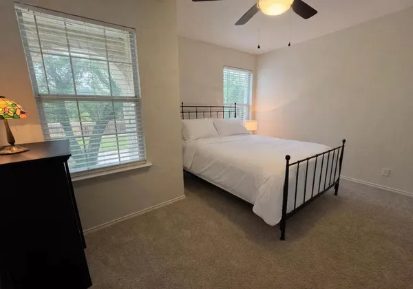 a bedroom with a bed and window