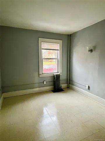 an empty room with a empty space and windows