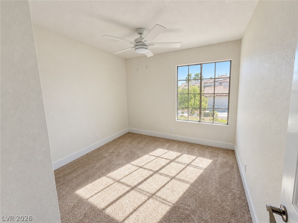 43 Bayridge Road Henderson, NV 89074 - Photo 45 of 47 Plentiful natural light streams across the carpeted floor of this tranquil bedroom space.
