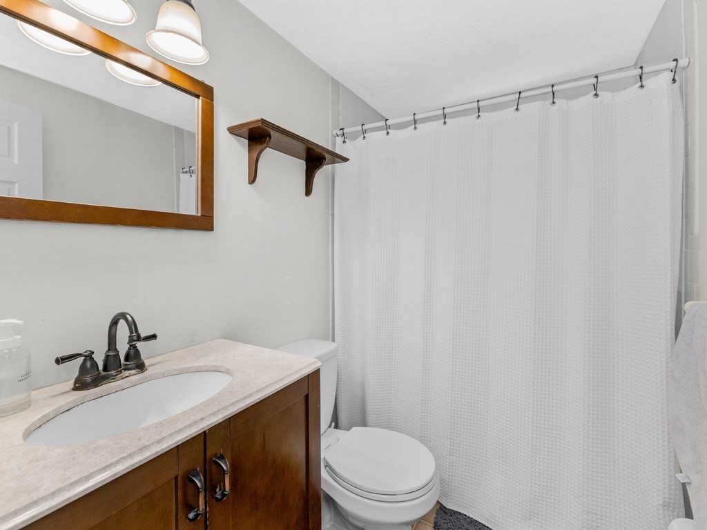 267 Salem Road Billerica, MA 01821 - Photo 13 of 27 a bathroom with a sink a toilet and shower
