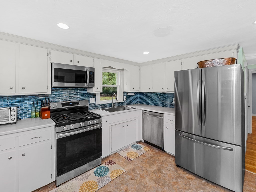 267 Salem Road Billerica, MA 01821 - Photo 4 of 27 a kitchen with a refrigerator stove and microwave