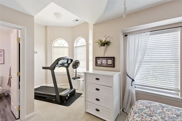 a view of a bedroom with gym equipment