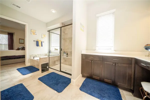 a spacious bedroom with a large window and a table