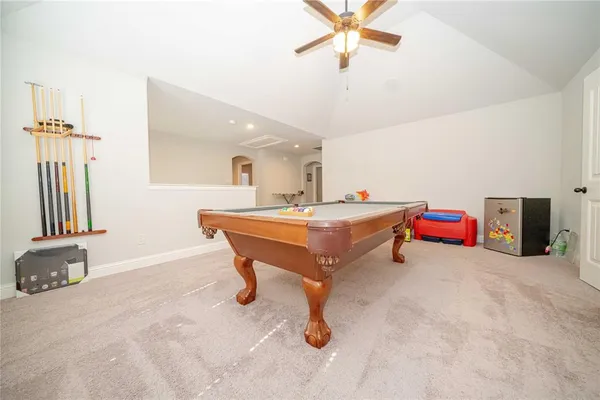 a room with pool table and windows