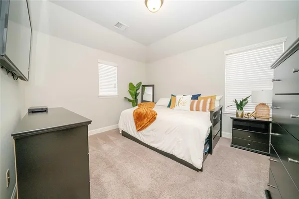 a bedroom with a bed and a flat screen tv