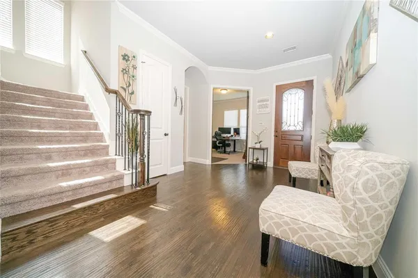 a living room with furniture a chandelier and a flat screen tv