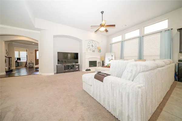 a kitchen with stainless steel appliances a table chairs refrigerator and a fireplace