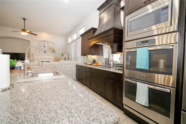 a kitchen with cabinets and chairs