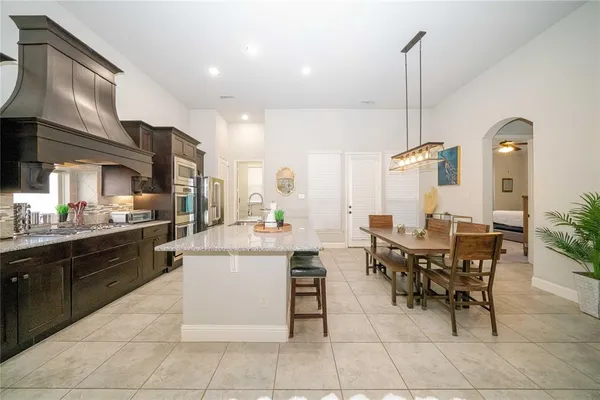 a kitchen with a table and chairs