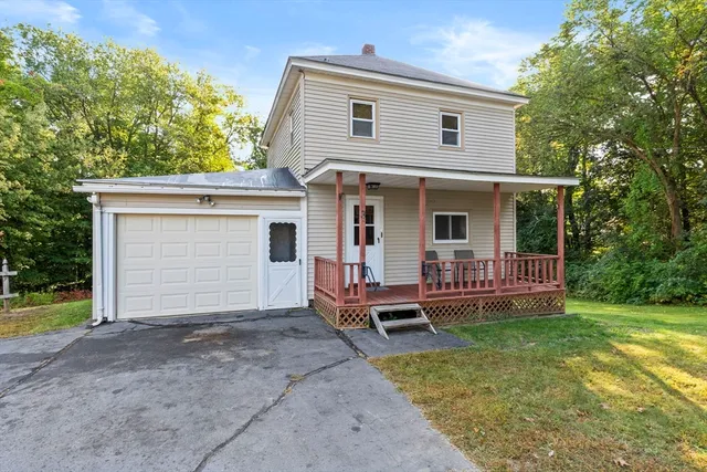 a view of a house with backyard and porch