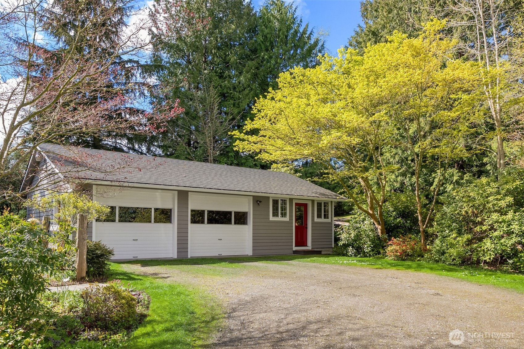 37695 Hansville Road Northeast Hansville, WA 98340 - Photo 23 of 37 a front view of a house with a yard and garage