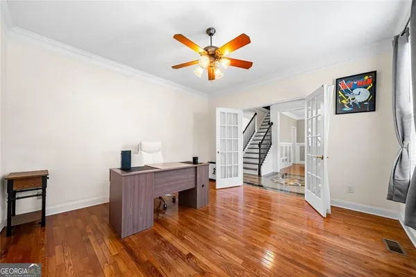 a view of a livingroom with a hardwood floor and a ceiling fan