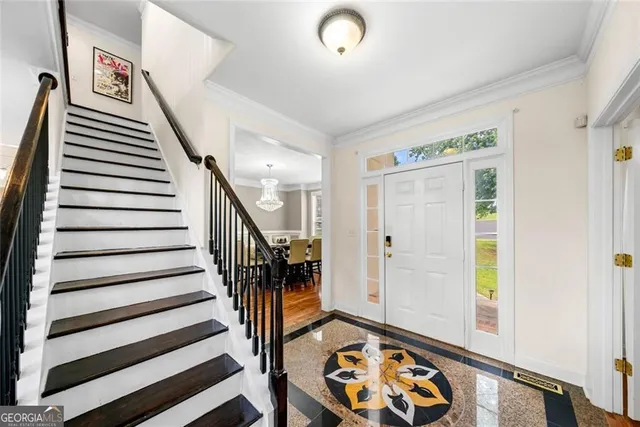 a view of entryway with wooden floor and stairs