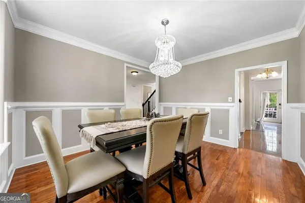a view of a dining room with furniture and wooden floor