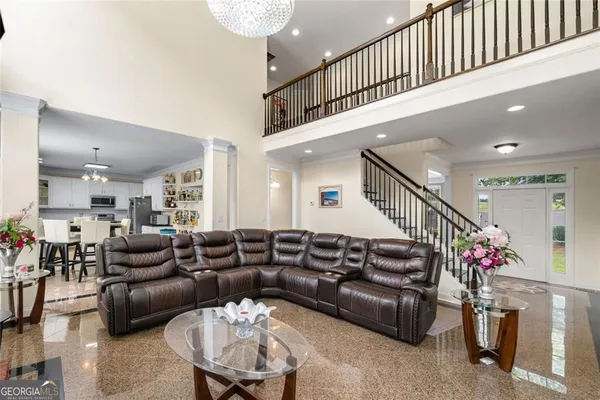 a living room with furniture and stairs