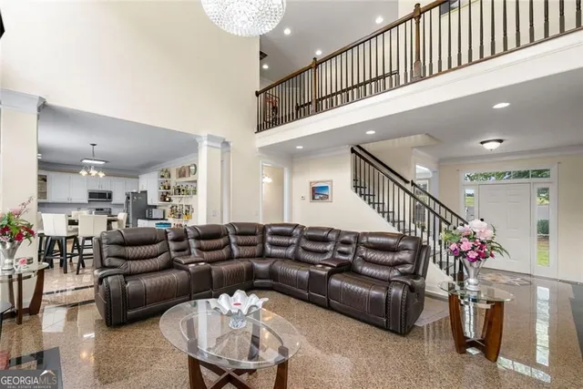 a living room with furniture and stairs