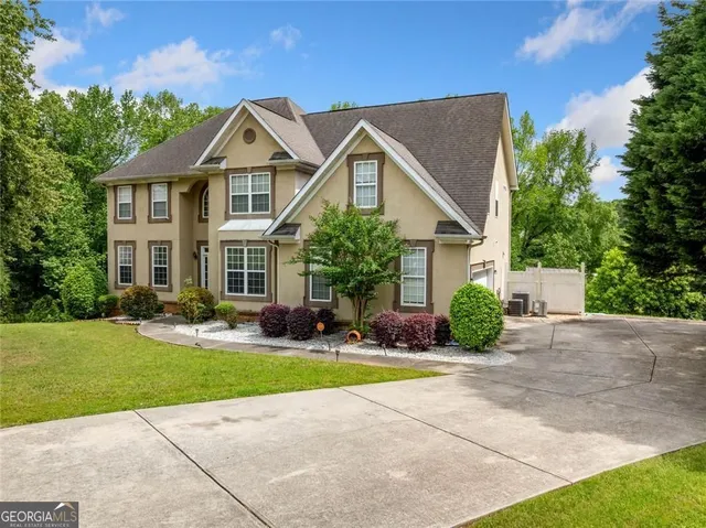 a front view of a house with a yard and garage