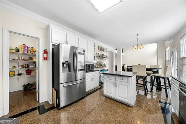 a kitchen with stainless steel appliances granite countertop a refrigerator and a sink