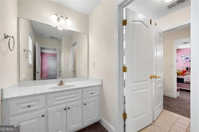 a en suite bathroom with a shower sink and mirror
