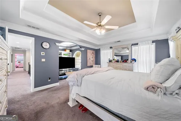 a bed room with a bed and a television