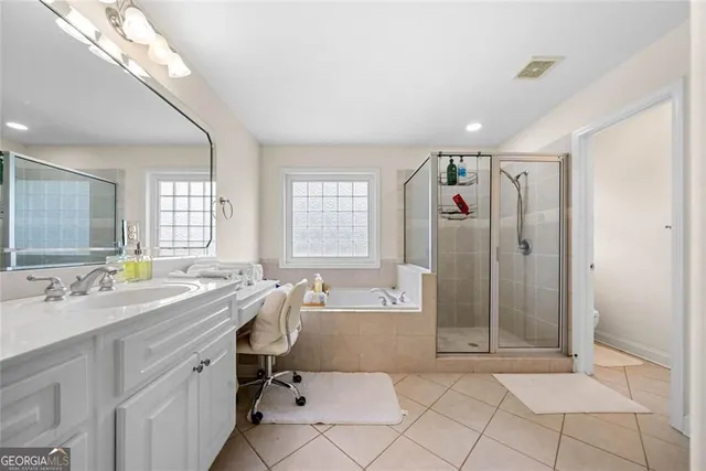 a view of a bathroom with dual sinks