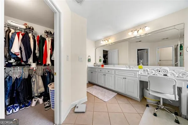 a view of a walk in closet with clothes