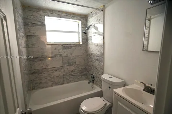 a bathroom with a bathtub toilet and sink