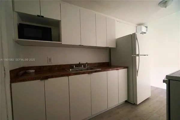 a kitchen with a refrigerator and a microwave